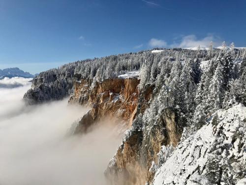 a mountain covered in snow and clouds at Haus Tilia Karinthië Appartementen in Nötsch