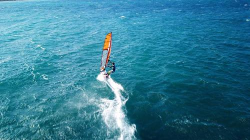 a person windsurfing in the ocean on the water at Terra Park SpiritoS in Kolan