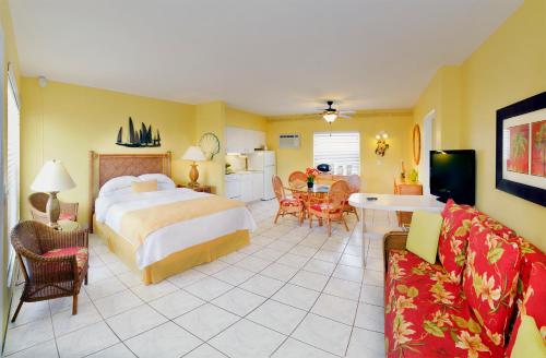 a hotel room with a bed and a living room at Tropic Seas Resort in Fort Lauderdale