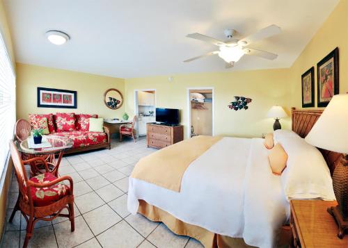 a bedroom with a large bed and a living room at Tropic Seas Resort in Fort Lauderdale