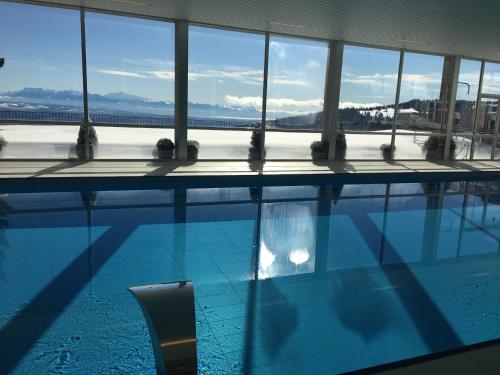 a swimming pool with a view of the water at Grand Hôtel des Rasses & Wellness in Les Rasses