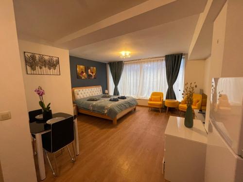 a bedroom with a bed and a table and chairs at Gîtes Sax 2 in Dinant