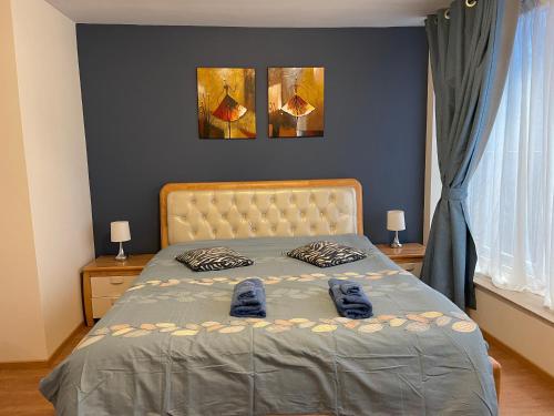 a bedroom with a bed with blue shoes on it at Gîtes Sax 2 in Dinant