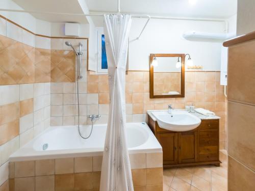 a bathroom with a tub and a sink at Stairway to the castle in Ljubljana