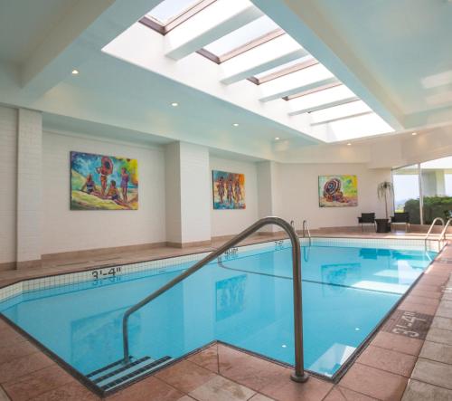 a swimming pool with a skylight in a hotel room at Inn at Laurel Point in Victoria