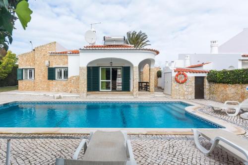 a villa with a swimming pool and a house at Oura Villa V3 com Piscina Privada in Albufeira