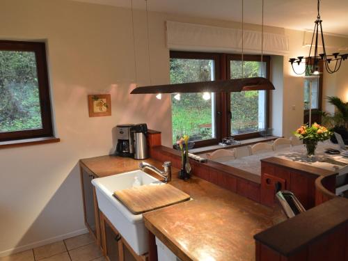 a kitchen with a sink and a counter top at Quaint Holiday Home in Robechies amid Meadows in Chimay