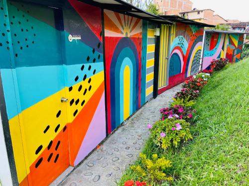 a colorful building with flowers on a sidewalk at La Madriguera in Guatapé
