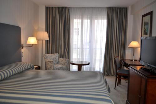 Säng eller sängar i ett rum på Hermitage Hotel