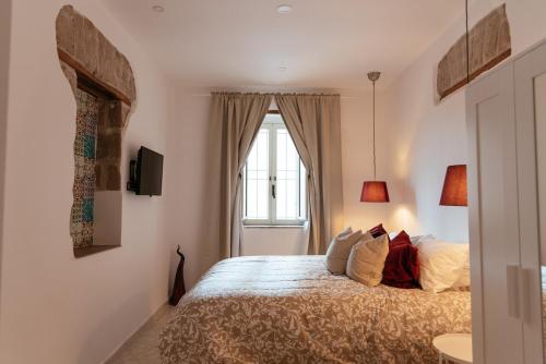 a bedroom with a bed and a window at Casa Aragona b&b in Capua