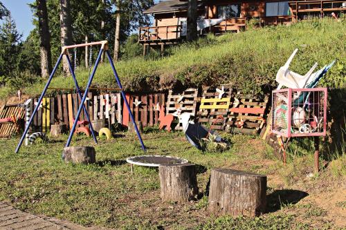 a playground with two swings and a swing at Cabañas Rapallo in Licán Ray
