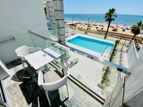 balcón con vistas a la piscina y a la playa en Hotel Apartamentos Marina Luz en Chipiona