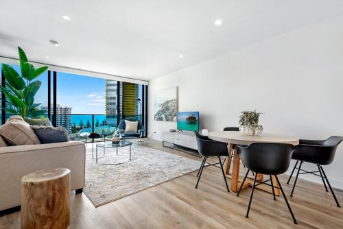 a living room with a table and a couch at Oracle Resort Broadbeach - gclr in Gold Coast