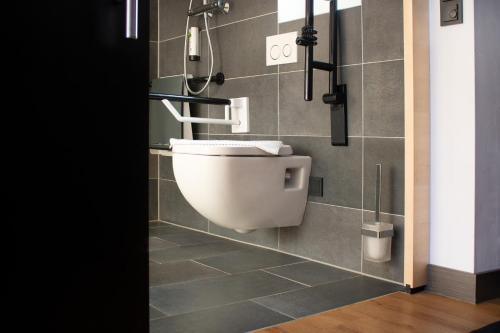 a bathroom with a toilet and a shower at KF Hotel by WMM Hotels in Kaufbeuren