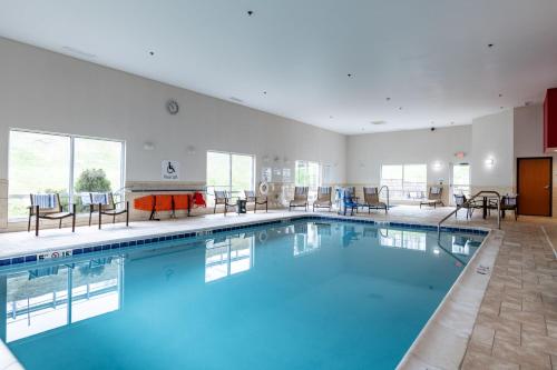 a large pool with blue water in a hotel room at Holiday Inn Express & Suites New Martinsville by IHG in New Martinsville