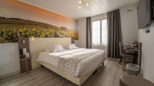 a bedroom with a bed with a painting on the wall at Best Western Hotel Ile de France in Château-Thierry