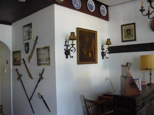 a room with a wall with crosses and clocks on the wall at Hotel an der Fähre in Sankt Goar