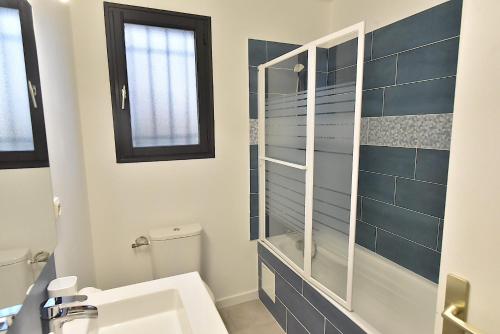 a bathroom with a toilet and a sink at Welcome Home in Vert-le-Grand