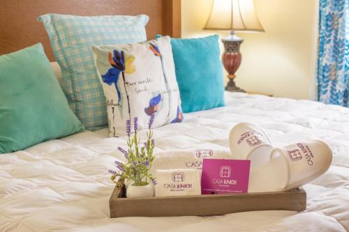 a bed with a tray with spa products on it at Casa Kinich in Guadalajara