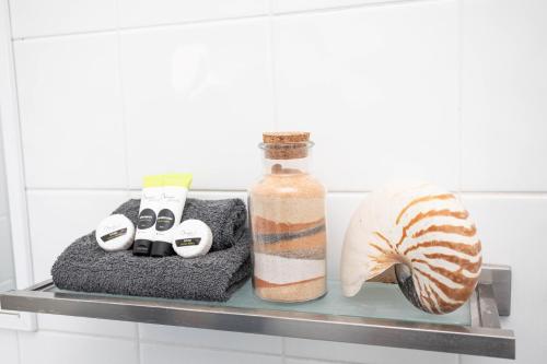 a shelf with a bottle and other items on it at Airlie Sun & Sand Accommodation #2 in Airlie Beach