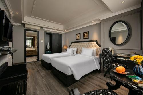 a bedroom with a large white bed and a mirror at Scent Premium Hotel in Hanoi