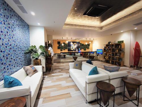 a store with couches and chairs in a lobby at Green Rich Hotel Miyazaki Tachibandori 2 (Artificial hot spring Futamata Yunohana) in Miyazaki