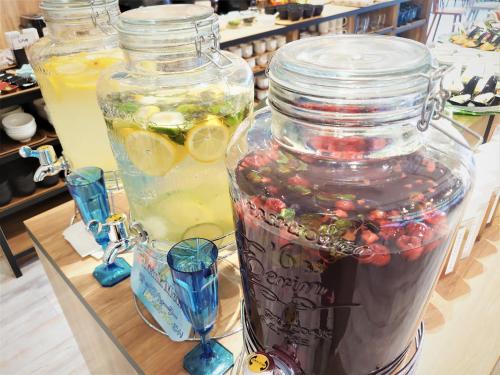 a glass jar filled with fruit and a drink at Green Rich Hotel Miyazaki Tachibandori 2 (Artificial hot spring Futamata Yunohana) in Miyazaki