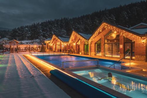 a swimming pool in a resort at night at Thermal Camping Velingrad in Velingrad