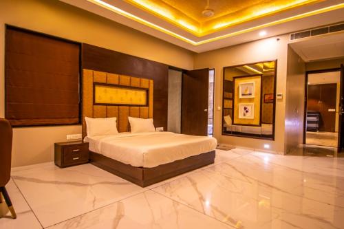 een slaapkamer met een groot bed in een kamer bij The Bhagwati Resort in Abu Road