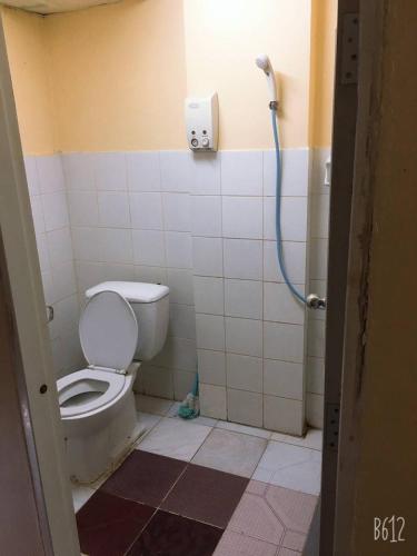 a bathroom with a toilet and a shower at SAM Apartment in Bangkok