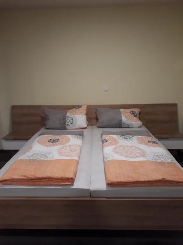 two beds with pillows sitting on top of it at Schoppenstube May in Weigenheim