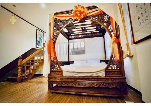 a room with a bed in a room with a staircase at Old Street Seaview Homestay in Jiufen