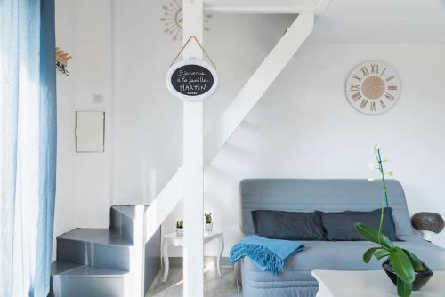 two views of a living room with a blue couch at Le Moulin de l'Etang in Chaneins