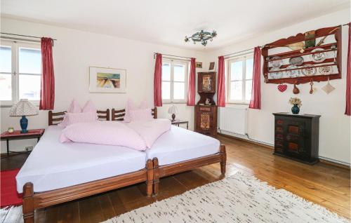a bedroom with a bed with pink pillows at Ferienhaus Im Defereggental in Gassen