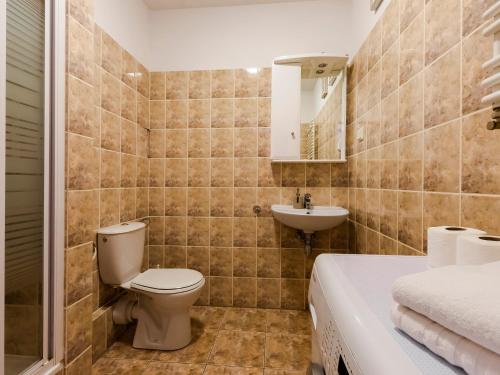 a bathroom with a toilet and a sink at VacationClub - Zielone Tarasy Apartament 51 in Kołobrzeg
