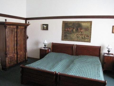 a bedroom with a bed and a painting on the wall at Zámok u Grofa in Nitra