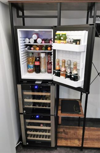 an open refrigerator filled with lots of food and drinks at FEWO am Neuen Dom in Linz