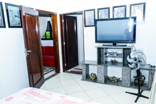 a living room with a tv and a tv stand at Belo Recanto in São José dos Campos