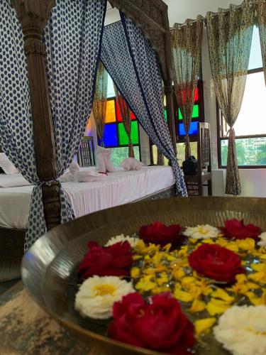 a room with a table with flowers on it at Soham Haveli Udaipur in Udaipur