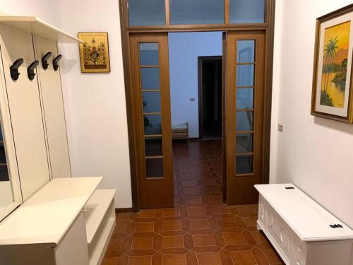 een kleedkamer met witte kasten en een spiegel bij Casa Lauretana in Loreto