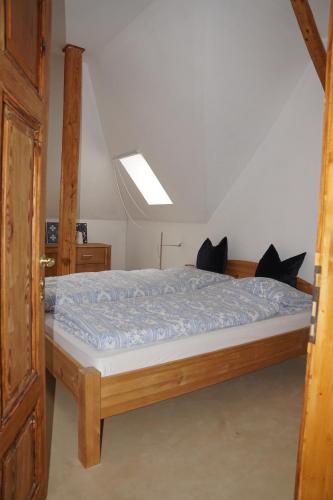 a bedroom with a bed with a blue comforter at Auberge Tabarz Inselsberg in Tabarz