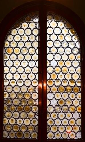 a window with a bunch of wine bottles at L'antica Bifore in Lucca