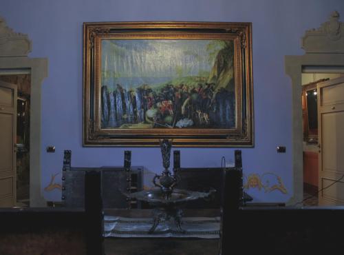 a painting hanging on a wall in a room at L'antica Bifore in Lucca