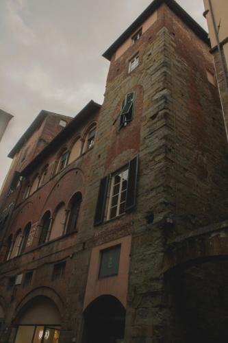 a tall brick building with windows on it at L'antica Bifore in Lucca