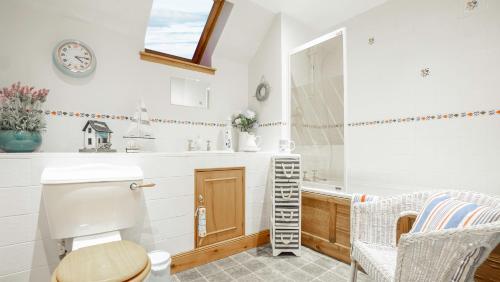 a bathroom with a toilet and a sink at Osborne Steading in St Andrews