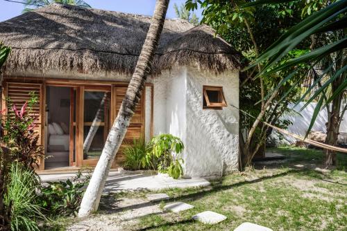 a house that has a tree in front of it at Casa Blanca in Holbox Island