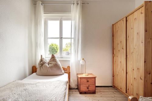 a bedroom with a bed and a window at Schloß Destille in Dormagen