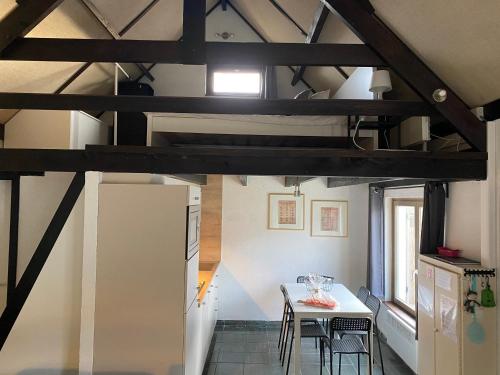 a kitchen and dining room with a table and chairs at vakantiehuisje 007 in Koksijde
