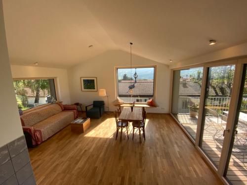 a living room with a couch and a table at Guesthouse Paradies Samerberg in Samerberg