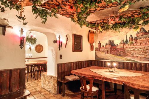 a restaurant with tables and a painting on the wall at Schloß Destille in Dormagen